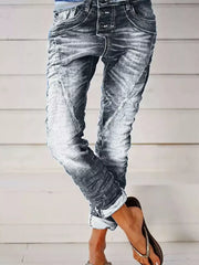 Grey cuffed button-fly jeans with a washed denim look and rolled cuffs.