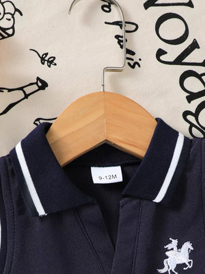 Navy sleeveless polo dress with white equestrian embroidery and striped collar.
