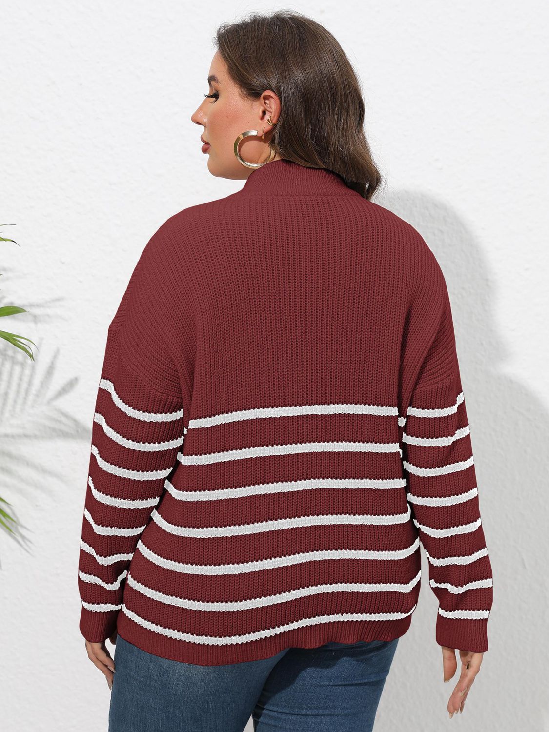 Burgundy ribbed knit sweater with white horizontal stripes and band collar.