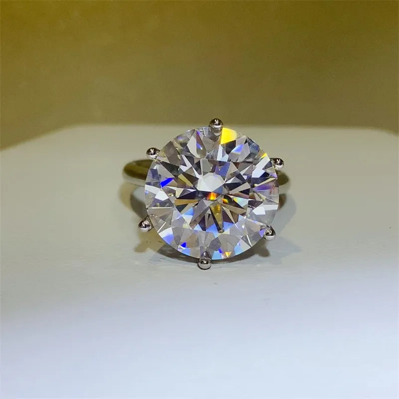 Silver solitaire ring with a large, faceted clear gemstone and six prong setting.