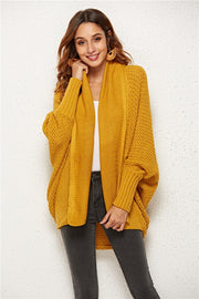Textured cocoon knit cardigan in gold with batwing sleeves and open front.