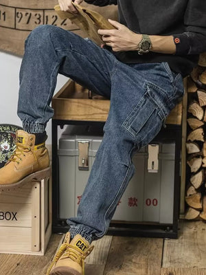 Men's vintage wash denim cargo jeans with elastic cuffs and side cargo pockets.