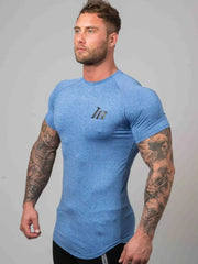 Sky blue performance fit raglan tee with black logo detail and short sleeves.