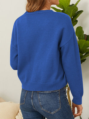 Royal blue V-neck cardigan with daisy embroidery and button front.