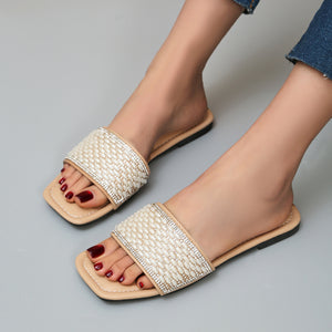 Chic open toe slide sandals in light brown with pearl and rhinestone embellished straps.