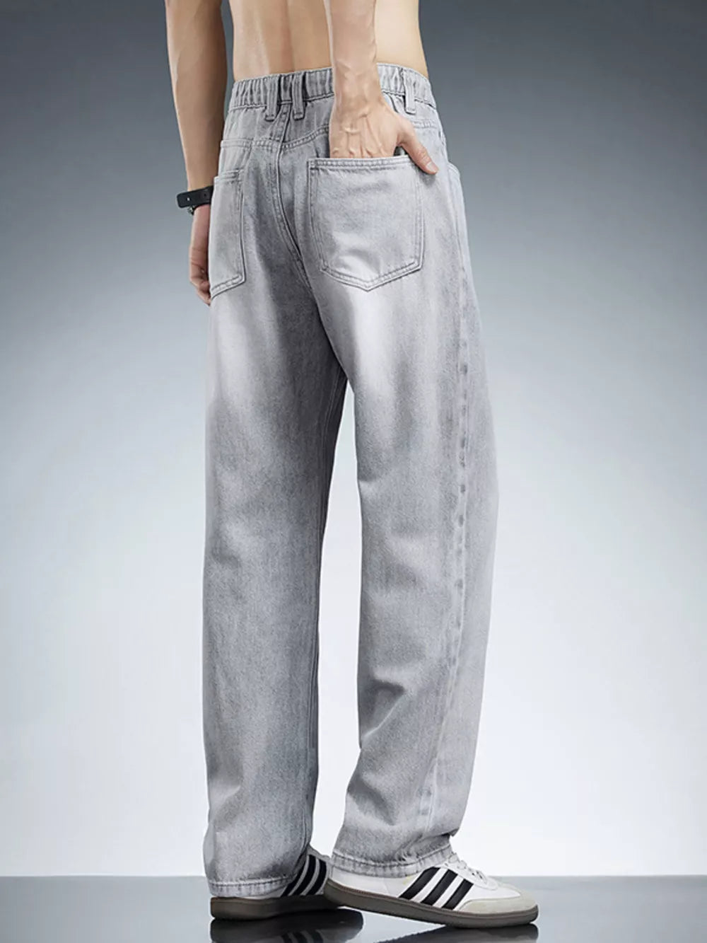 Men's relaxed fit light grey wide leg jeans in cotton with elastic waistband.