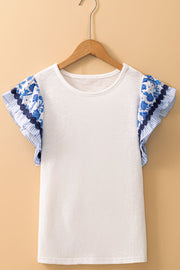 White tee with blue floral embroidered flutter sleeves and ruffled trim.
