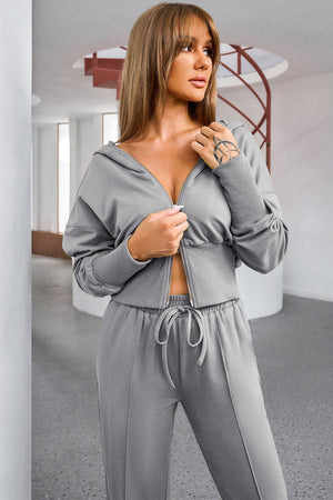 Dark gray cropped zip-up hoodie and wide leg lounge pants set with drawstring waist.