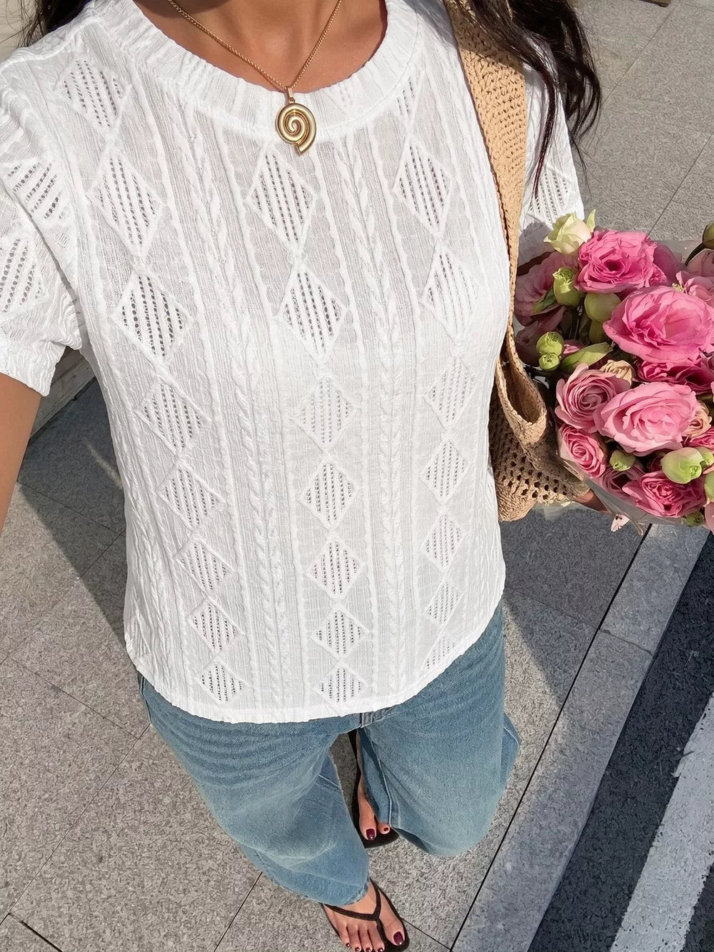 White textured knit maternity t-shirt with crew neck and diamond pattern detail.