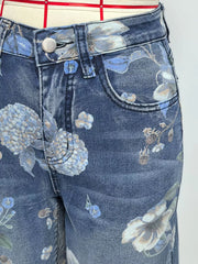 Blue denim shorts with a botanical print and relaxed fit.