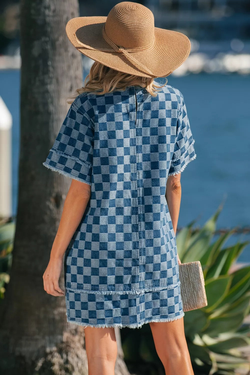 Checkered denim mini dress with frayed hems and short sleeves.