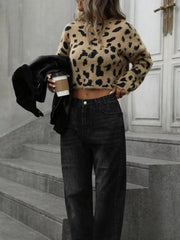Cropped fuzzy leopard print knit sweater with a crew neck and long sleeves.