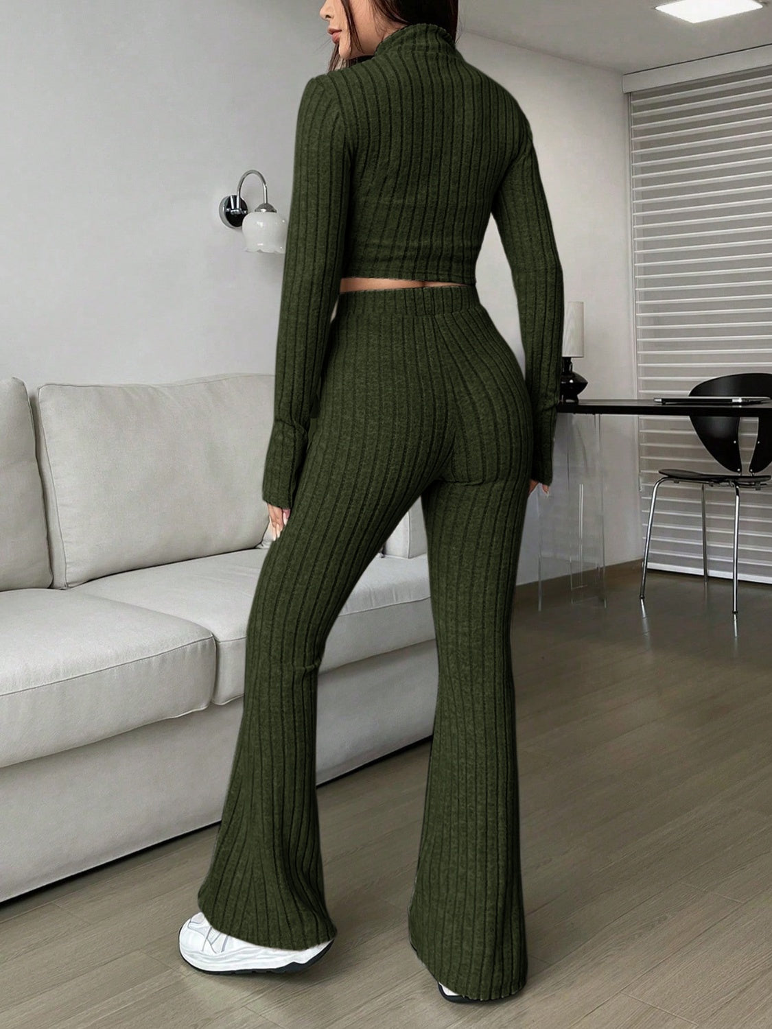 Ribbed knit crop top and flare pants set in army green, styled casually.