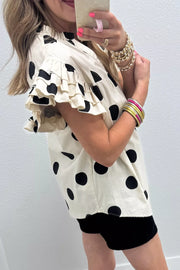 Cream cotton shirt with black polka dots, V-neck, and ruffled short sleeves.