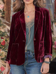 Burgundy velvet blazer with rolled cuff detail and buttoned front, styled with jeans.