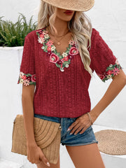 Burgundy embroidered eyelet v-neck peasant top with floral trim on neckline and sleeves.