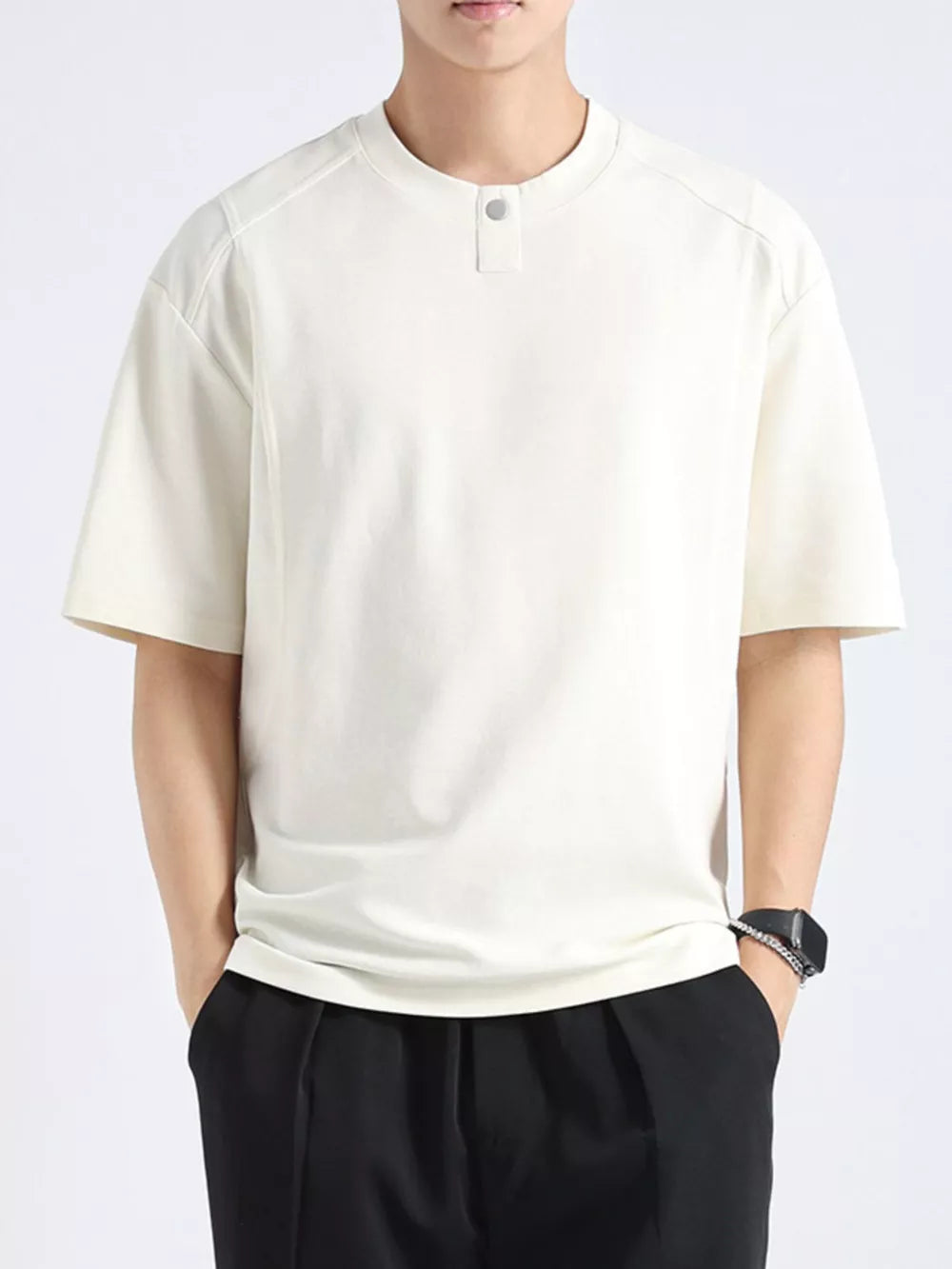 Apricot cotton henley tee with short sleeves and a button detail at the neckline.