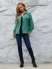 Textured corduroy button-up jacket in Peacock Green with chest pockets and silver buttons.