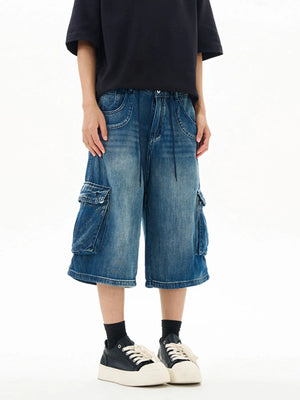 Relaxed fit vintage blue denim cargo shorts with drawstring waist and flap pockets.