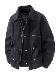 Black corduroy trucker jacket with buttoned pockets and zip detail.