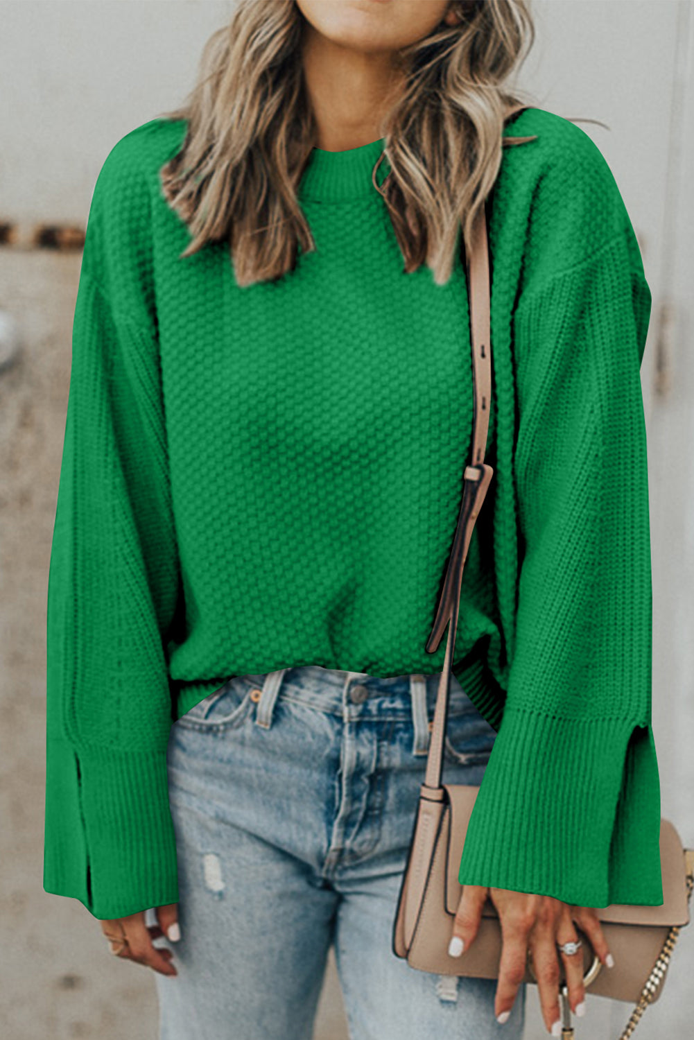 Green textured knit sweater with crew neck and split bell sleeves.