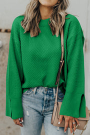 Green textured knit sweater with crew neck and split bell sleeves.