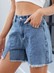 Light blue denim shorts with frayed hem and high split sides.