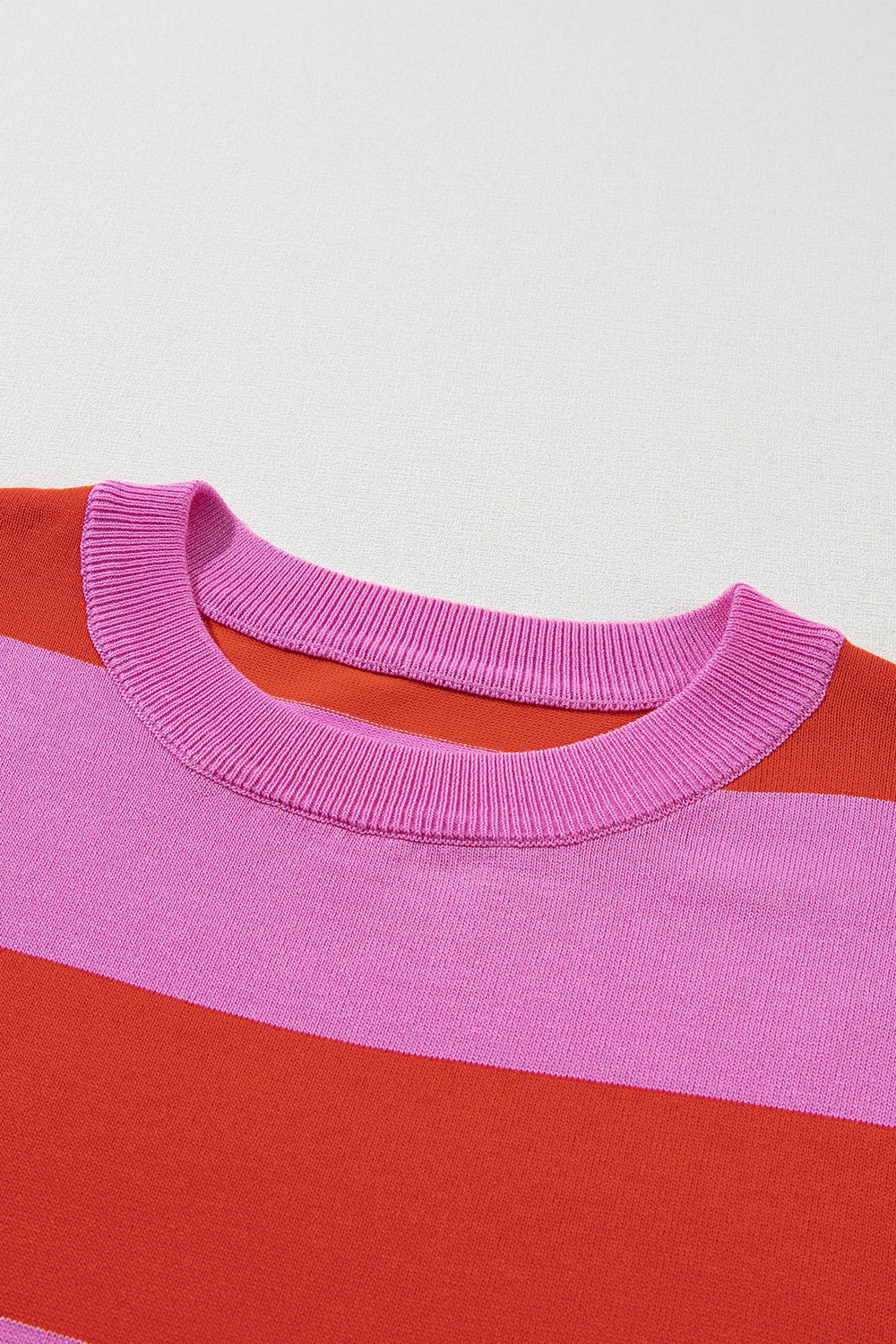 Striped knit tee in hot pink and red with a ribbed crew neck.