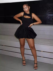 Black cutout mini dress with bubble hem and sleeveless design.
