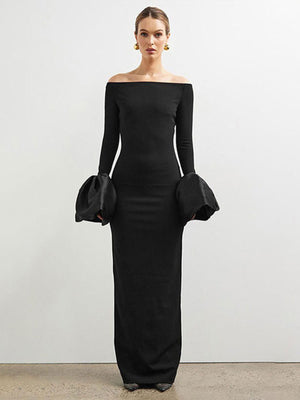 Black off-shoulder maxi dress with dramatic voluminous sleeves and a bodycon fit.