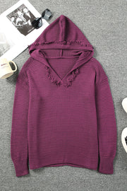 Textured knit hooded pullover in burgundy with frayed trim and V-neck.