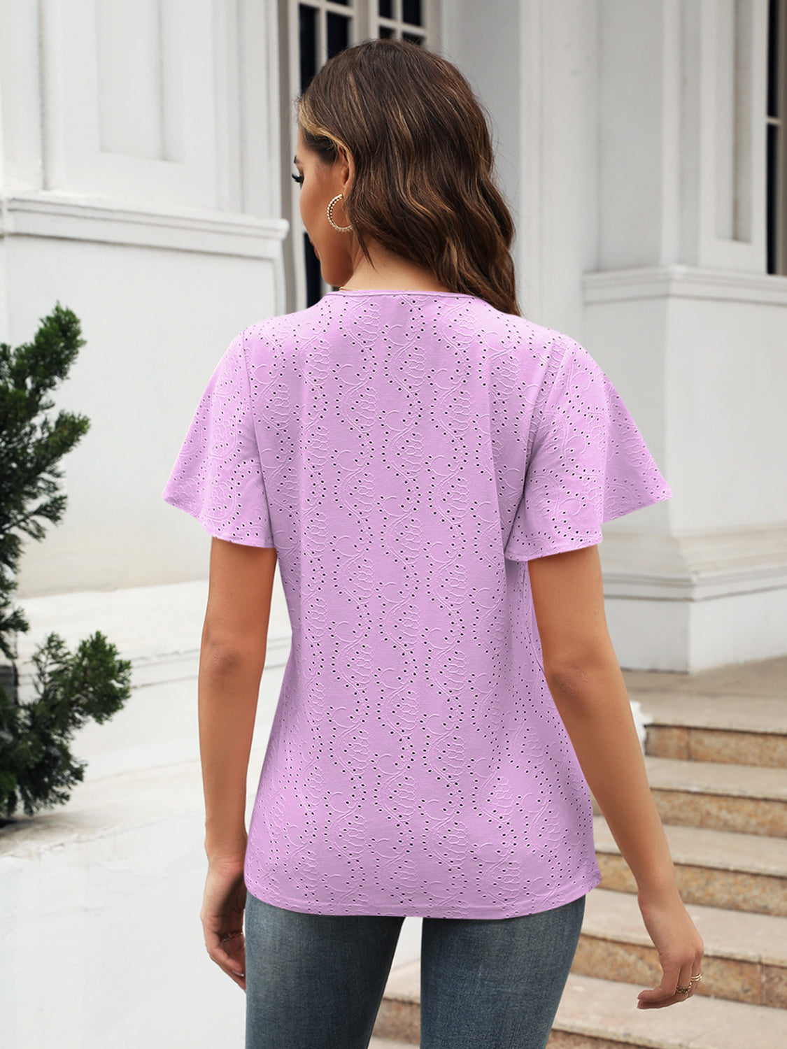 Blush pink eyelet blouse with flutter sleeves and V-neck.