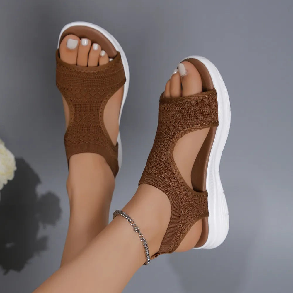 Caramel knit sandals with cutouts and white soles.