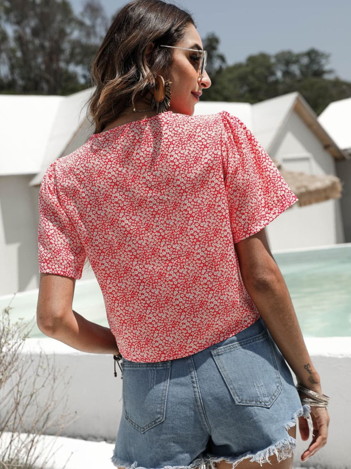 Red petal print ruched crop top with short sleeves and a V-neck.