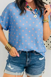 Blue ribbed knit tee with pink polka dots, cuffed short sleeves, and crew neck.