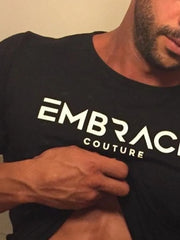 Black t-shirt with white Embrace Couture logo, crew neck, short sleeves.