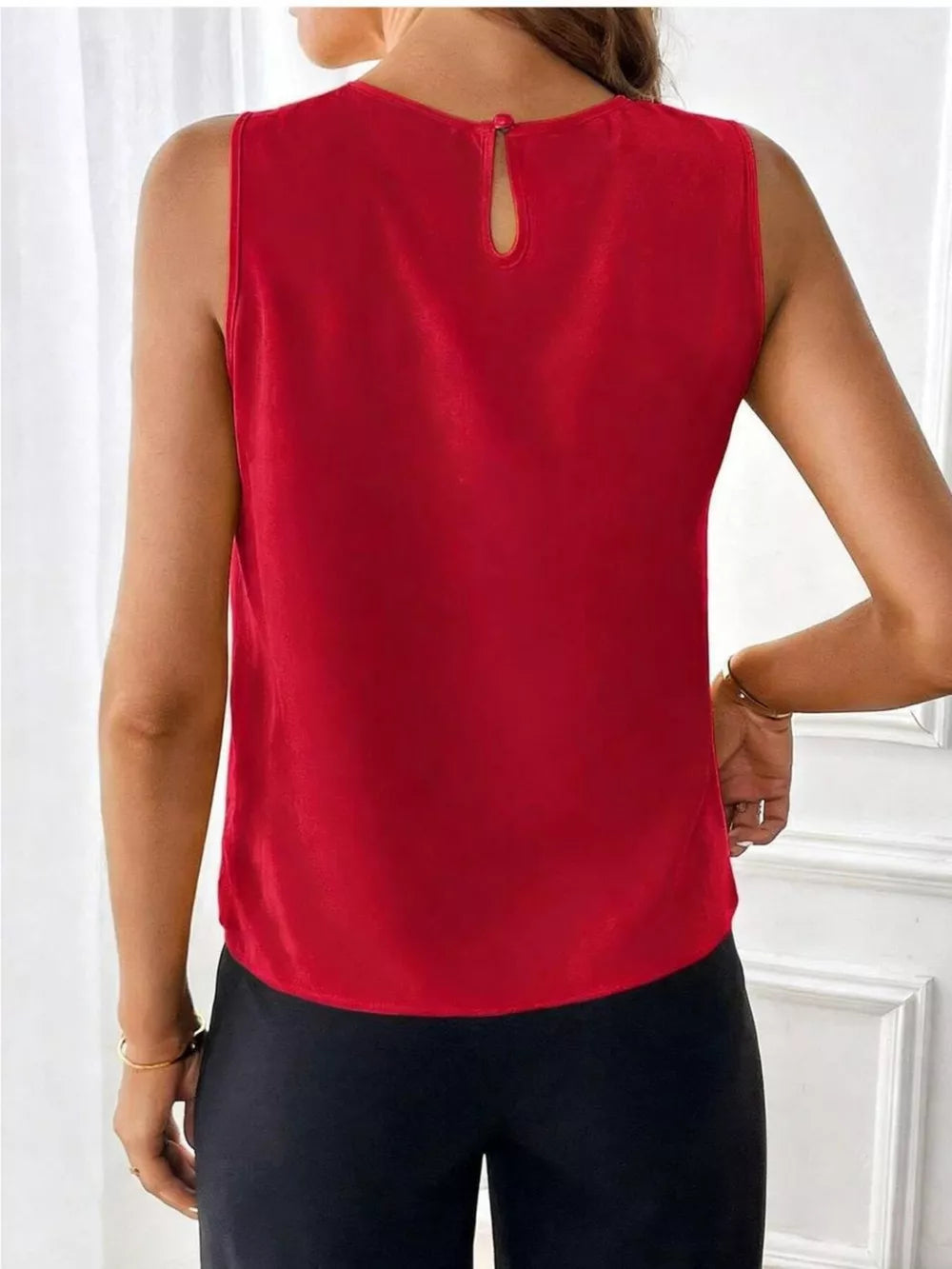 Red sleeveless tank top with keyhole neckline and button closure