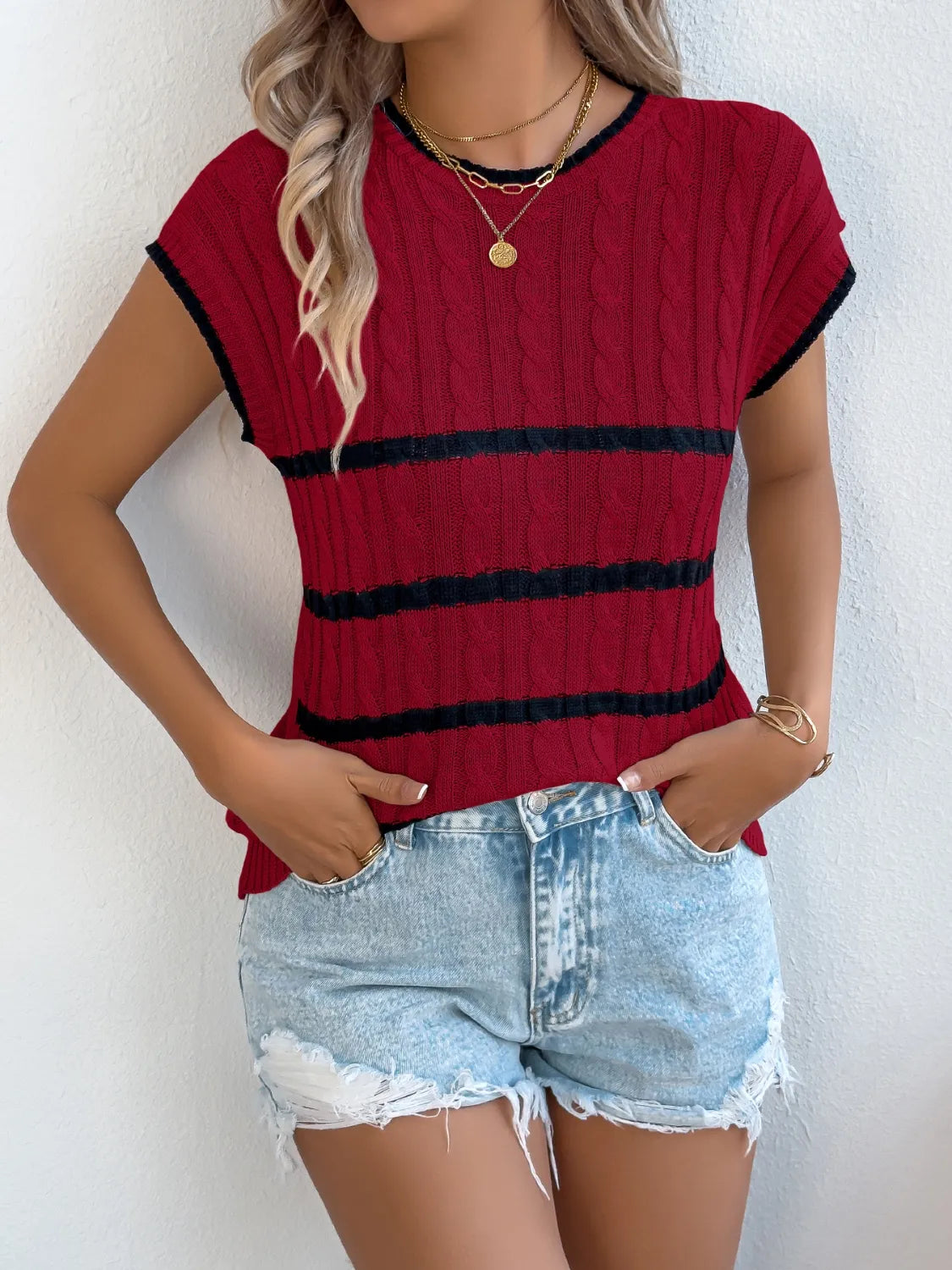 Sleeveless cable knit stripe sweater in white, khaki, or deep red.