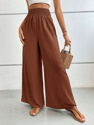 Textured palazzo lounge trousers in rust with a smocked waistband and wide legs.