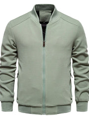 Sage green textured knit bomber jacket with faux shearling lining and zip closure.