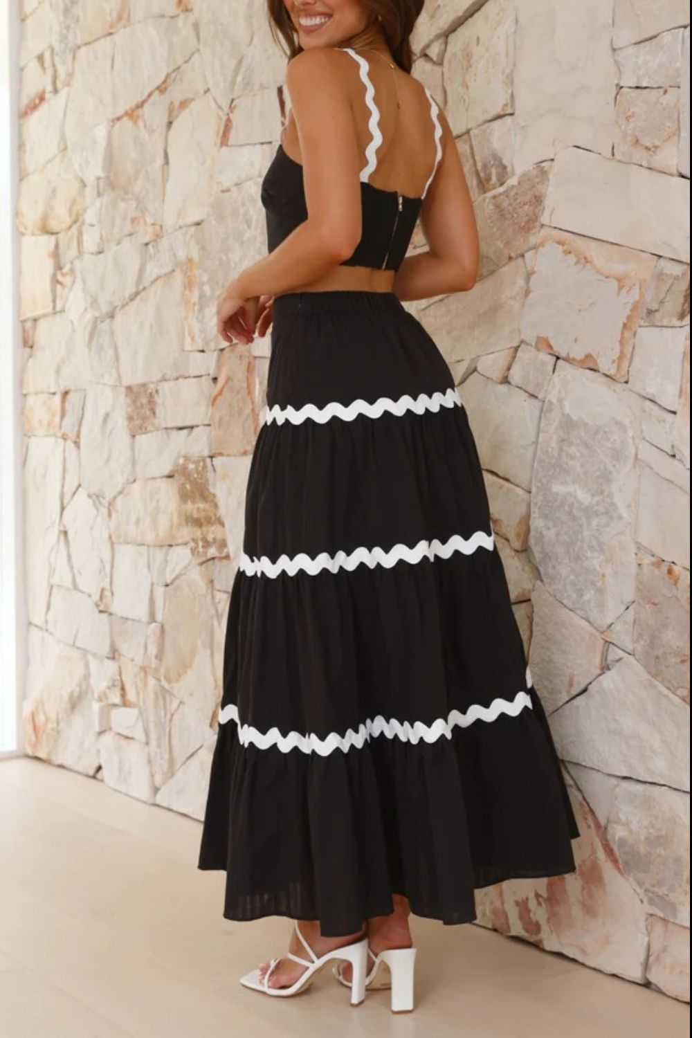Black crop top and tiered maxi skirt set with white scalloped trim detail.