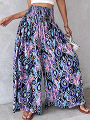 Bohemian print wide-leg pants with smocked waist and flowing silhouette.