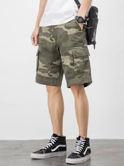 Men's plus-size relaxed fit cargo shorts in green camouflage with multiple pockets.