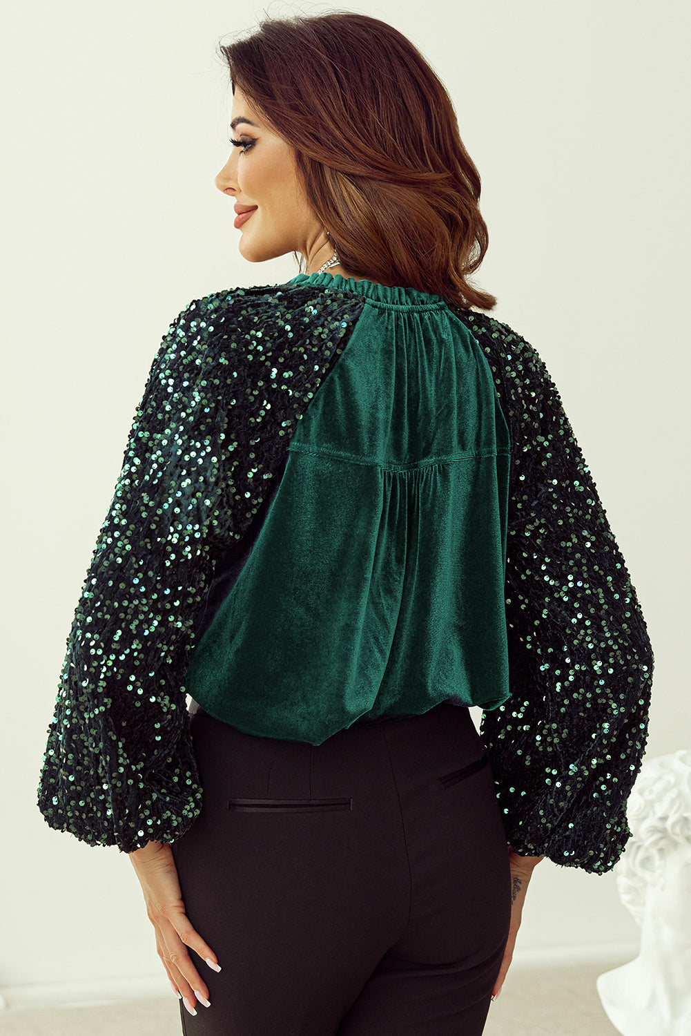 Dark green velvet blouse with sequin sleeves and gathered neckline detail.