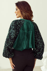 Dark green velvet blouse with sequin sleeves and gathered neckline detail.