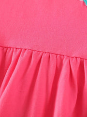 Strawberry pink cotton dress with ruffled hem and bird appliques detail.