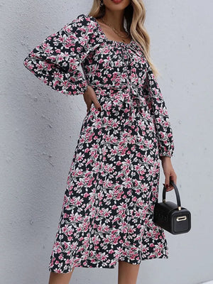 Black floral midi dress with square neckline, long balloon sleeves, and tie waist.
