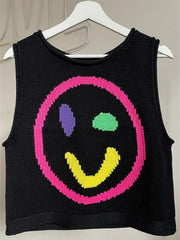 Black knit tank top with a colorful smiley face graphic and pink trim.