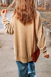 Oversized sand washed cotton sweatshirt with side slits and crew neck.