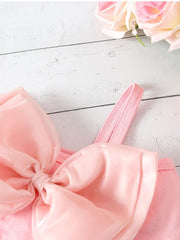 Pink bikini top with large satin bowknot detail and spaghetti strap.